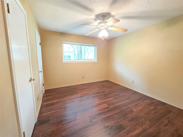 11902 25th St, Santa Fe, TX 77510 - unfurnished bedroom featuring dark wood-style floors, a textured ceiling, baseboards, and a ceiling fan