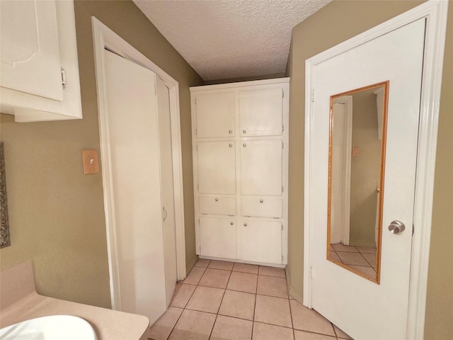 11902 25th St, Santa Fe, TX 77510 - corridor with light tile patterned floors and a textured ceiling