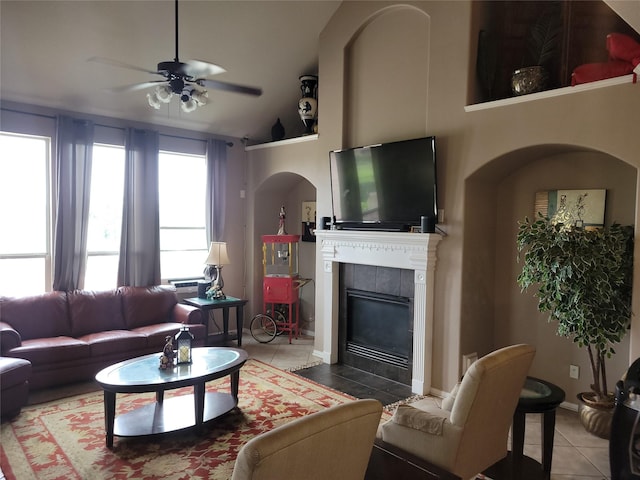5647 Horseshoe Fls, Missouri City, TX 77459 - living area featuring tile patterned flooring, ceiling fan, a tiled fireplace, and arched walkways