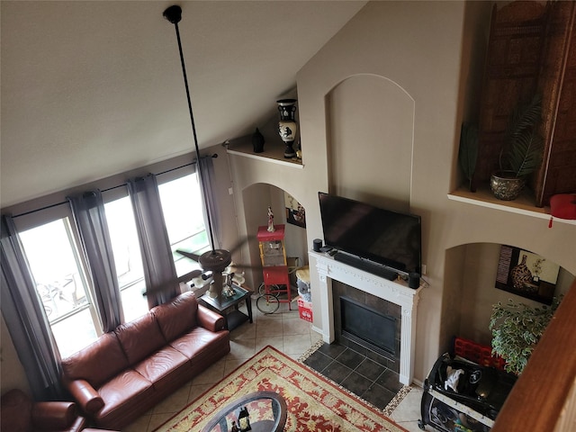 5647 Horseshoe Fls, Missouri City, TX 77459 - tiled living room featuring a tiled fireplace and vaulted ceiling