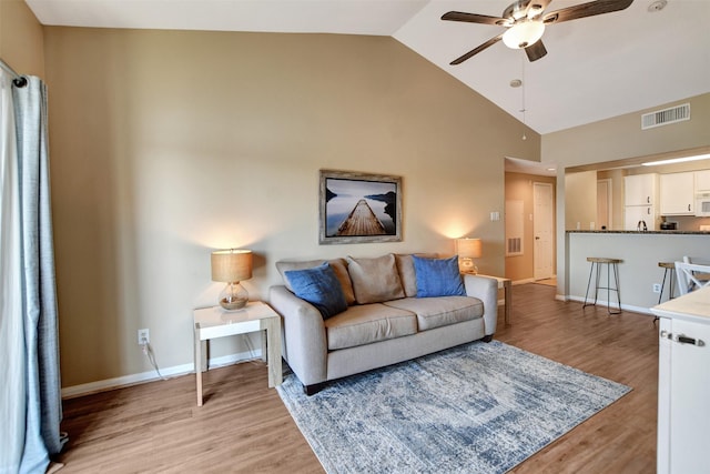 12800 Melville Dr Unit B302, Montgomery, TX 77356 - living room with a ceiling fan, light wood finished floors, high vaulted ceiling, and baseboards