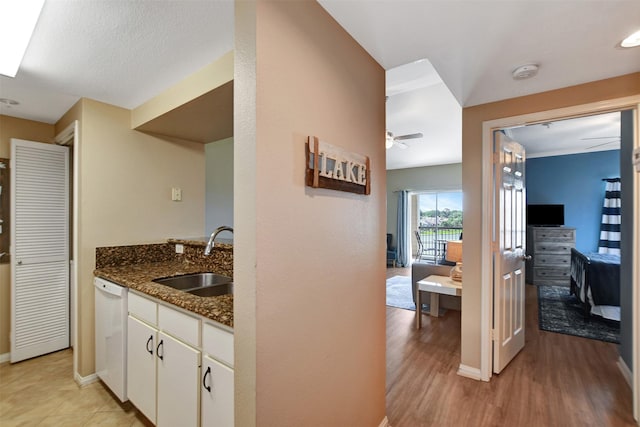 12800 Melville Dr Unit B302, Montgomery, TX 77356 - kitchen featuring a sink, white dishwasher, white cabinetry, ceiling fan, and dark stone countertops