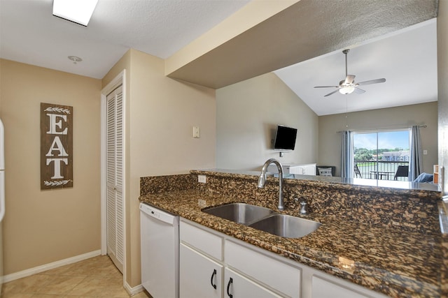 12800 Melville Dr Unit B302, Montgomery, TX 77356 - kitchen with dishwasher, a sink, dark stone countertops, white cabinetry, and vaulted ceiling