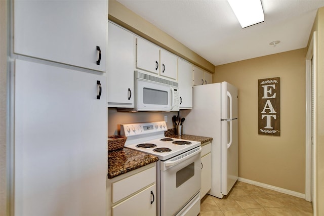 12800 Melville Dr Unit B302, Montgomery, TX 77356 - kitchen featuring white appliances, white cabinetry, light tile patterned floors, and baseboards