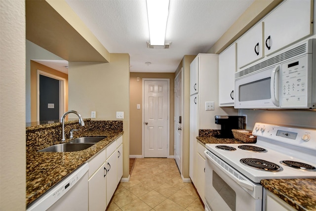 12800 Melville Dr Unit B302, Montgomery, TX 77356 - kitchen featuring white appliances, a sink, white cabinets, and light tile patterned floors