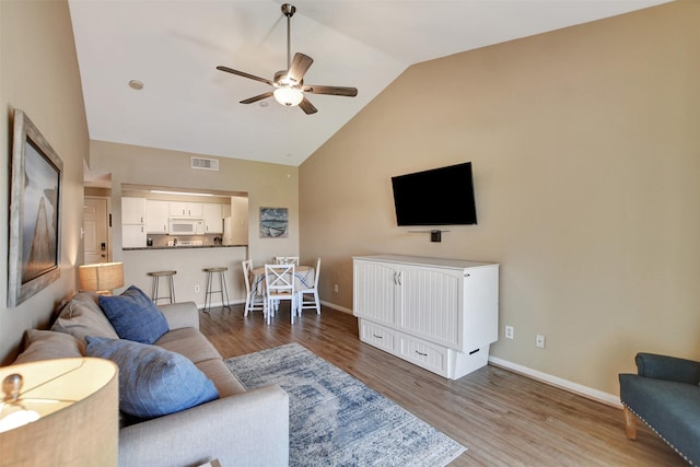 12800 Melville Dr Unit B302, Montgomery, TX 77356 - living area with a ceiling fan, wood finished floors, baseboards, and high vaulted ceiling