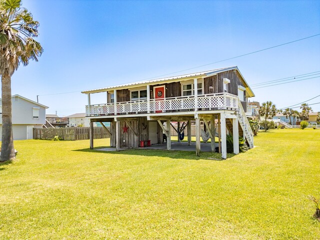 16519 Captain Kidd Rd, Jamaica Beach, TX 77554 - rear view of property featuring a sunroom, a deck, and stairs