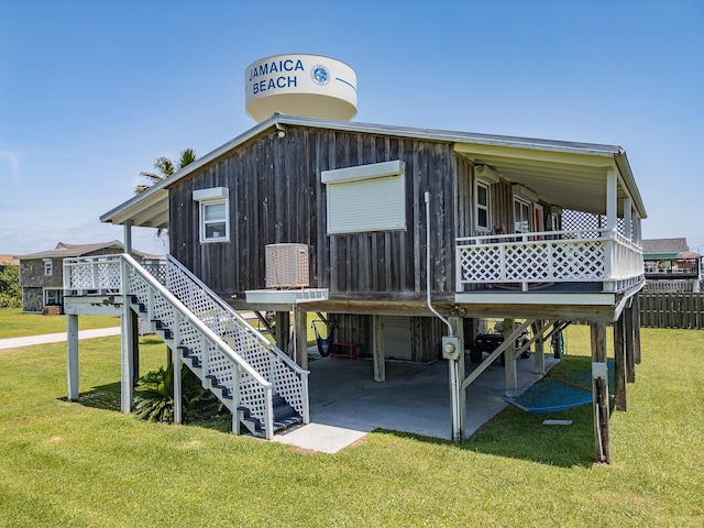 16519 Captain Kidd Rd, Jamaica Beach, TX 77554 - rear view of property with a lawn, stairway, a deck, a carport, and a patio area