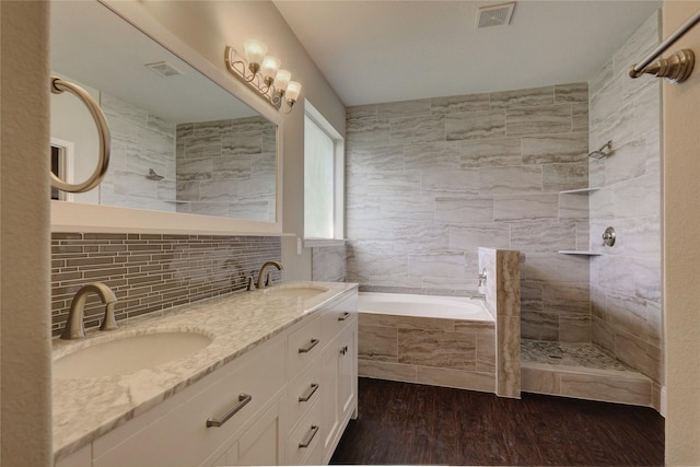 10567 Sunflower Dr, Conroe, TX 77318 - full bath with a garden tub, wood finished floors, double vanity, decorative backsplash, and walk in shower
