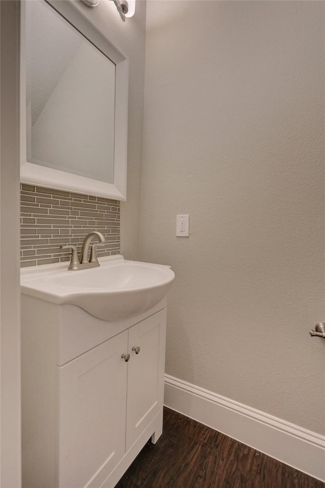 10567 Sunflower Dr, Conroe, TX 77318 - bathroom featuring vanity, baseboards, backsplash, and wood finished floors