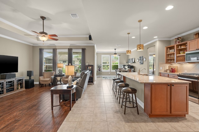231 Ranch House Ln, Richmond, TX 77469 - kitchen with appliances with stainless steel finishes, open floor plan, recessed lighting, crown molding, and ceiling fan