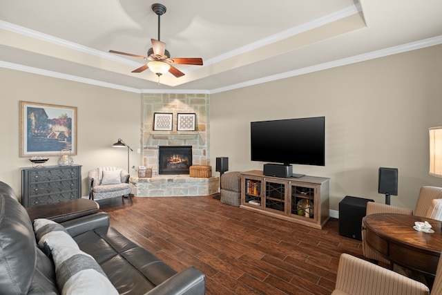 231 Ranch House Ln, Richmond, TX 77469 - living area featuring a tray ceiling, wood finished floors, ceiling fan, a fireplace, and ornamental molding
