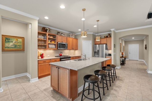 231 Ranch House Ln, Richmond, TX 77469 - kitchen featuring appliances with stainless steel finishes, arched walkways, tasteful backsplash, recessed lighting, and a kitchen bar