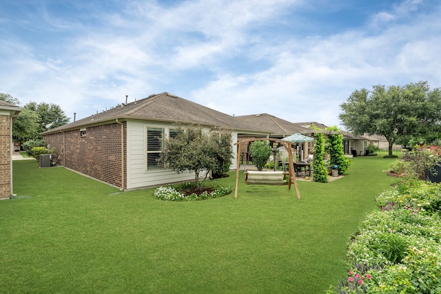 231 Ranch House Ln, Richmond, TX 77469 - back of property with a yard, brick siding, and a patio area
