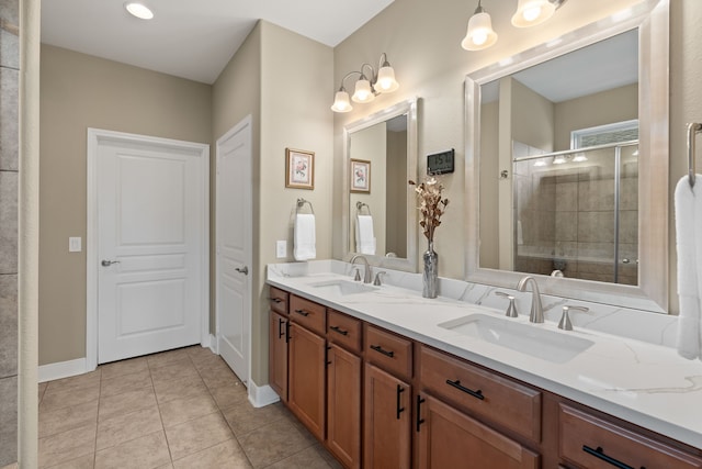 231 Ranch House Ln, Richmond, TX 77469 - full bathroom featuring double vanity, tile patterned flooring, and a shower stall