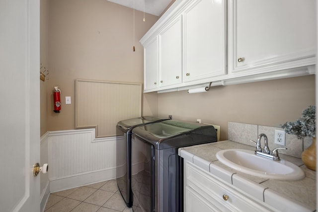 28655 Deer Run St, Montgomery, TX 77356 - washroom with independent washer and dryer, cabinet space, wainscoting, and light tile patterned flooring
