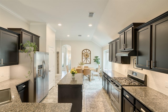 2947 Twin Cove Ct, Conroe, TX 77301 - kitchen featuring stainless steel appliances, arched walkways, decorative backsplash, crown molding, and stone countertops