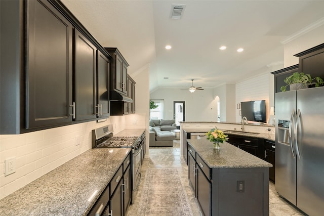 2947 Twin Cove Ct, Conroe, TX 77301 - kitchen featuring appliances with stainless steel finishes, crown molding, backsplash, open floor plan, and a ceiling fan