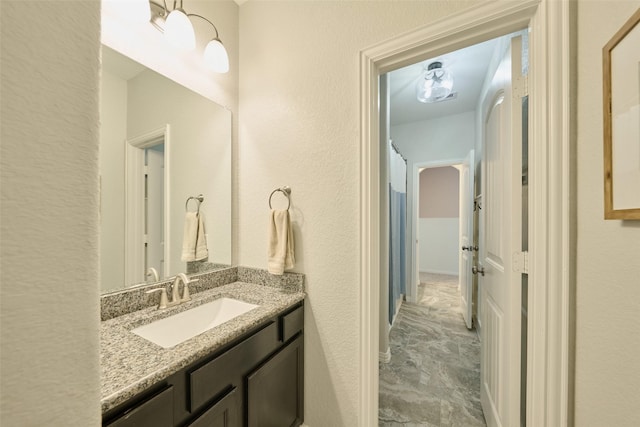 2947 Twin Cove Ct, Conroe, TX 77301 - bathroom with vanity and a textured wall