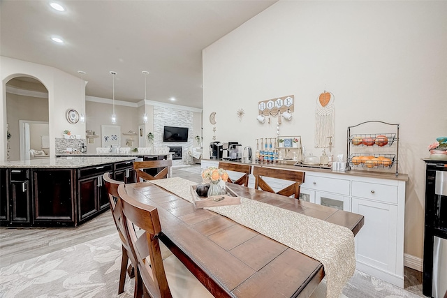 9103 Acorn Harvest Trl, Richmond, TX 77407 - dining space featuring arched walkways, ornamental molding, recessed lighting, and light wood-style flooring