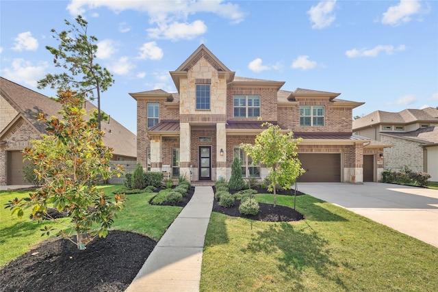 17346 Camillia Trl, Conroe, TX 77302 - view of front of house with a standing seam roof, driveway, an attached garage, a front lawn, and stone siding