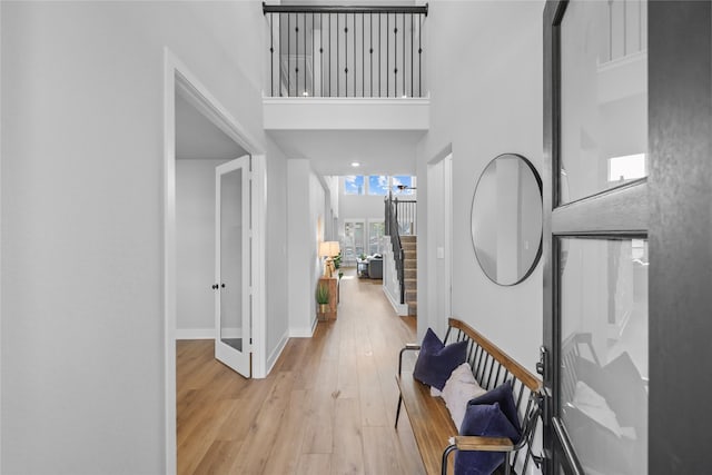 17346 Camillia Trl, Conroe, TX 77302 - foyer featuring a towering ceiling, light wood-style flooring, and baseboards