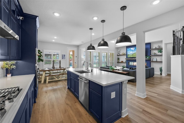17346 Camillia Trl, Conroe, TX 77302 - kitchen with blue cabinetry, a sink, stainless steel appliances, light countertops, and light wood-style flooring
