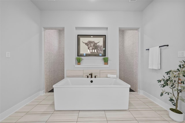 17346 Camillia Trl, Conroe, TX 77302 - bathroom featuring a freestanding bath, baseboards, and tile patterned flooring
