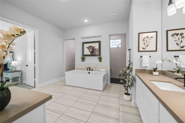 17346 Camillia Trl, Conroe, TX 77302 - full bath featuring a freestanding bath, vanity, tile patterned flooring, recessed lighting, and baseboards