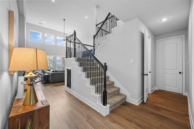 17346 Camillia Trl, Conroe, TX 77302 - stairs with wood finished floors, baseboards, a towering ceiling, and recessed lighting
