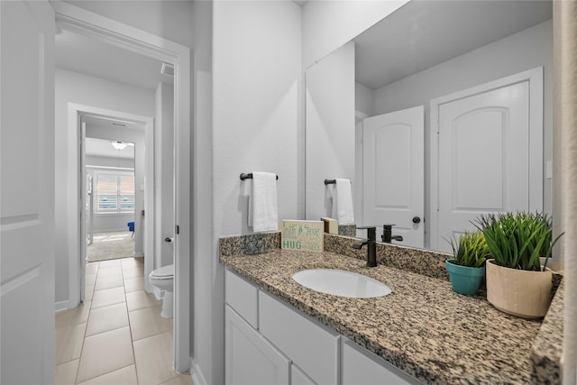 17346 Camillia Trl, Conroe, TX 77302 - bathroom featuring toilet, vanity, tile patterned floors, and baseboards
