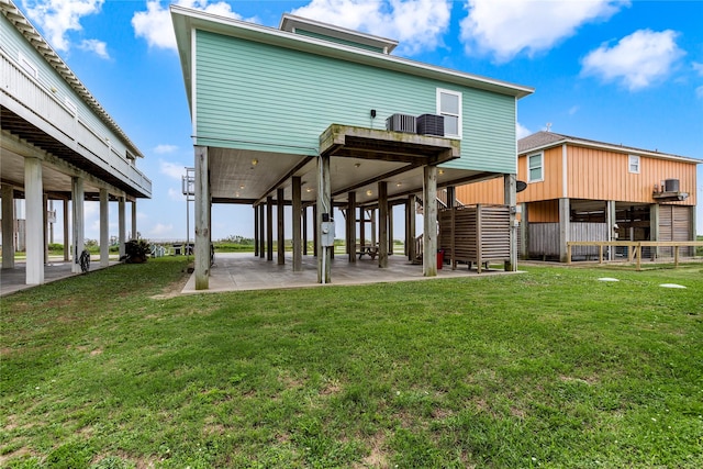 1317 Emerald Dr, Crystal Beach, TX 77650 - back of property featuring a lawn