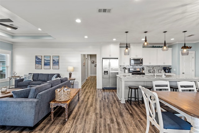 1317 Emerald Dr, Crystal Beach, TX 77650 - living room featuring dark wood finished floors, ornamental molding, recessed lighting, and ceiling fan