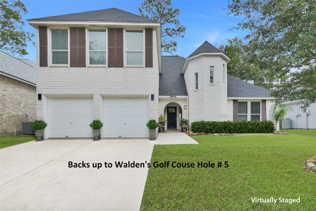 13646 Leafy Arbor Dr, Montgomery, TX 77356 - traditional-style home with driveway, an attached garage, a front lawn, a shingled roof, and cooling unit