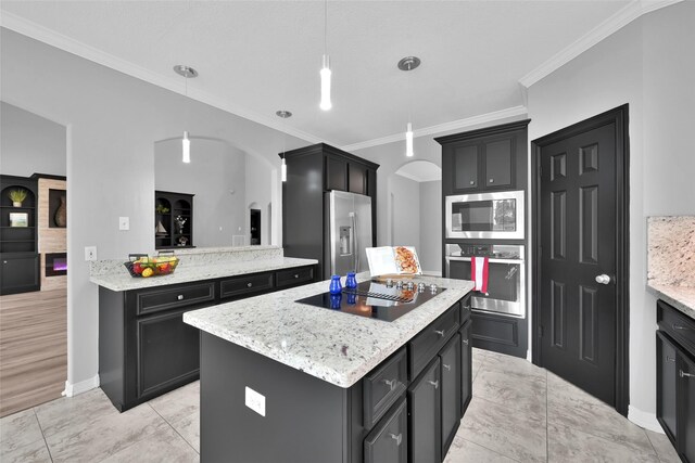 13646 Leafy Arbor Dr, Montgomery, TX 77356 - kitchen with stainless steel appliances, arched walkways, a kitchen island, ornamental molding, and hanging light fixtures
