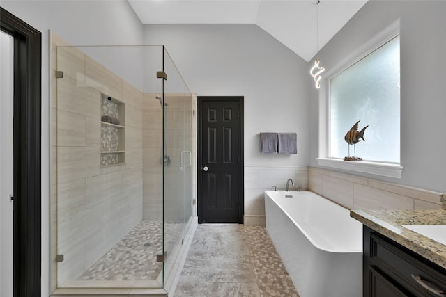 13646 Leafy Arbor Dr, Montgomery, TX 77356 - full bath with a soaking tub, tile walls, a shower stall, vanity, and vaulted ceiling