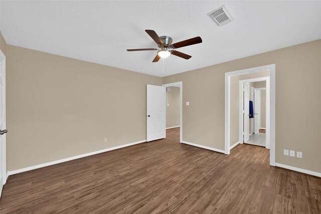 13646 Leafy Arbor Dr, Montgomery, TX 77356 - unfurnished bedroom with wood finished floors, baseboards, and ceiling fan