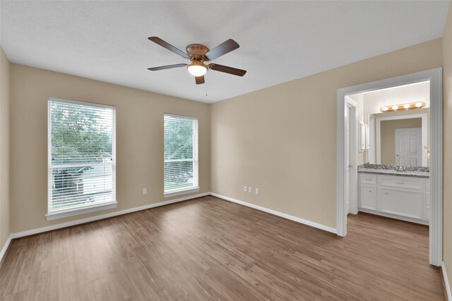 13646 Leafy Arbor Dr, Montgomery, TX 77356 - empty room featuring ceiling fan, light wood finished floors, baseboards, and a sink