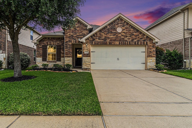 23722 Willow Haven Dr, Spring, TX 77389 - view of front of home with a garage, driveway, a yard, brick siding, and stone siding