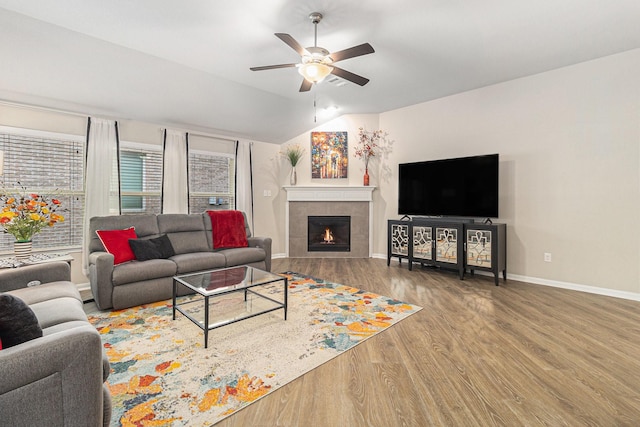 23722 Willow Haven Dr, Spring, TX 77389 - living area with ceiling fan, vaulted ceiling, wood finished floors, a tile fireplace, and baseboards