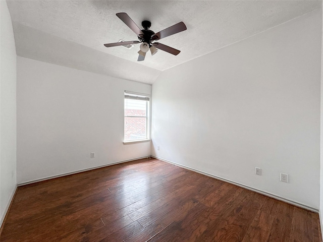 15319 Ochre Leaf Trl, Cypress, TX 77433 - empty room with wood finished floors, ceiling fan, vaulted ceiling, baseboards, and a textured ceiling