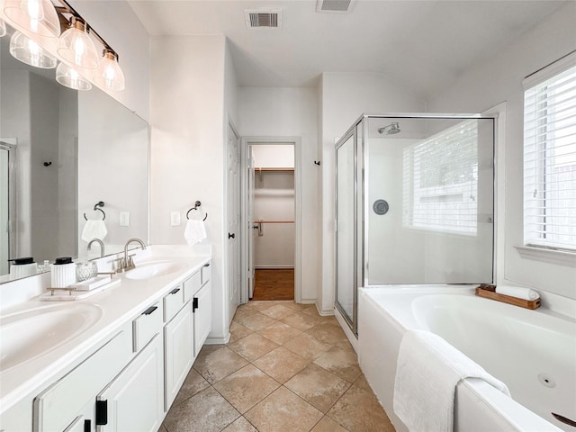 15319 Ochre Leaf Trl, Cypress, TX 77433 - full bathroom featuring a stall shower, a garden tub, double vanity, and a walk in closet