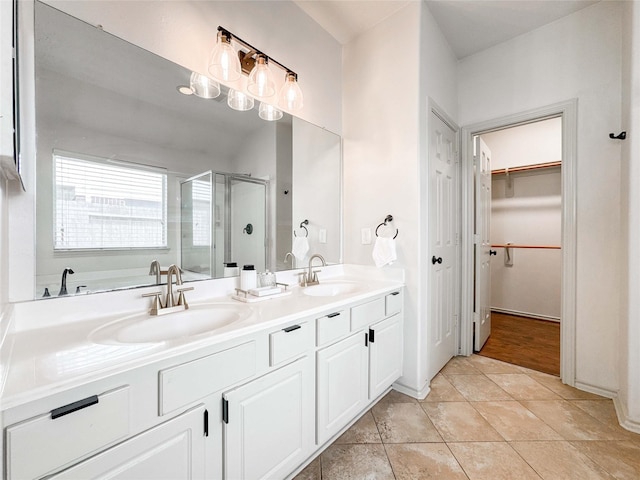 15319 Ochre Leaf Trl, Cypress, TX 77433 - full bath with a stall shower, double vanity, a spacious closet, a bath, and tile patterned floors