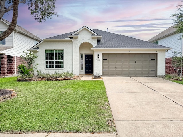 15319 Ochre Leaf Trl, Cypress, TX 77433 - view of front of property with roof with shingles, a garage, concrete driveway, a lawn, and brick siding