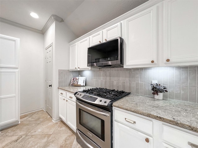 15319 Ochre Leaf Trl, Cypress, TX 77433 - kitchen with gas range, decorative backsplash, white cabinets, light stone countertops, and crown molding