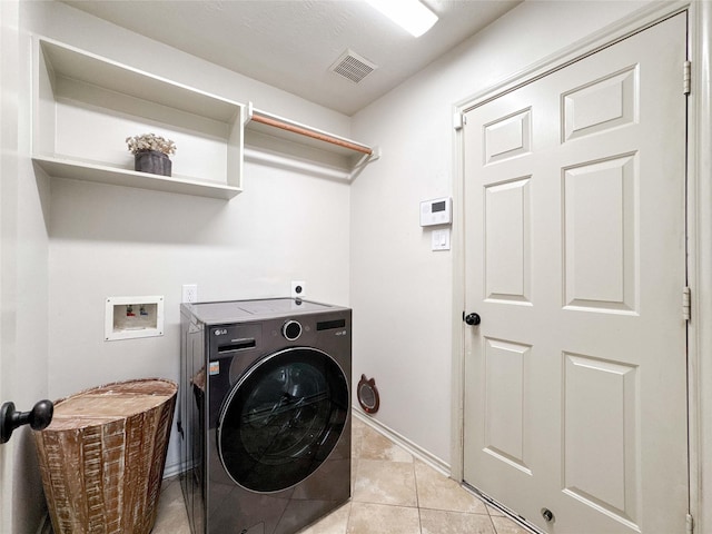 15319 Ochre Leaf Trl, Cypress, TX 77433 - laundry area with washer / dryer, light tile patterned flooring, and baseboards