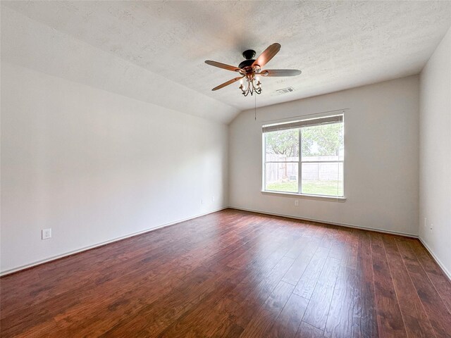 15319 Ochre Leaf Trl, Cypress, TX 77433 - unfurnished room featuring dark wood-style floors, a ceiling fan, a textured ceiling, lofted ceiling, and baseboards