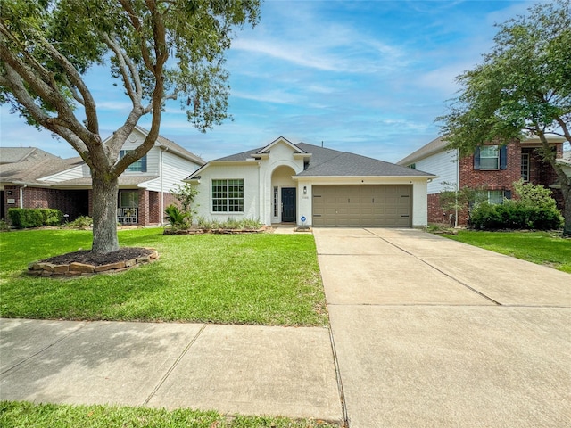 15319 Ochre Leaf Trl, Cypress, TX 77433 - single story home featuring a garage, a front lawn, concrete driveway, stucco siding, and a shingled roof