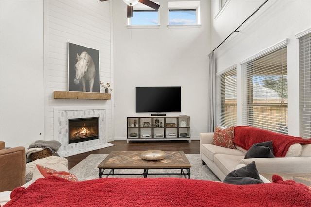 27121 Holtwood Grove Rd, Magnolia, TX 77354 - living room with a towering ceiling, ceiling fan, wood finished floors, and a high end fireplace