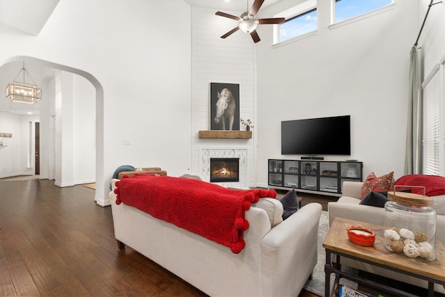 27121 Holtwood Grove Rd, Magnolia, TX 77354 - living area with a high ceiling, ceiling fan, dark wood finished floors, a large fireplace, and a chandelier